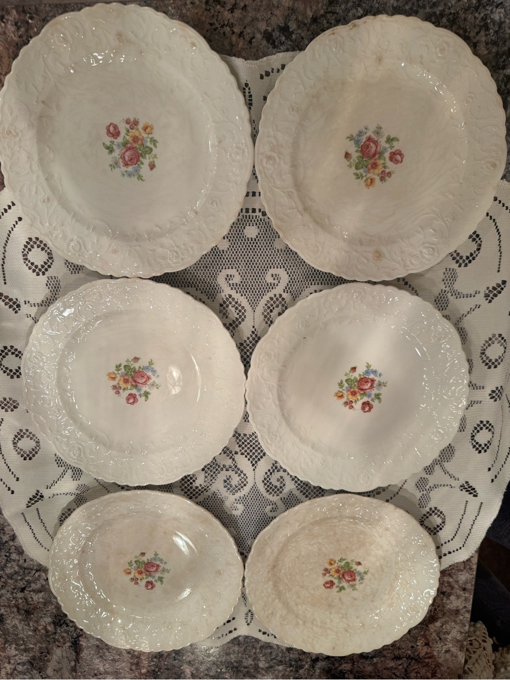 Vintage embossed floral plate featuring a central bouquet of roses